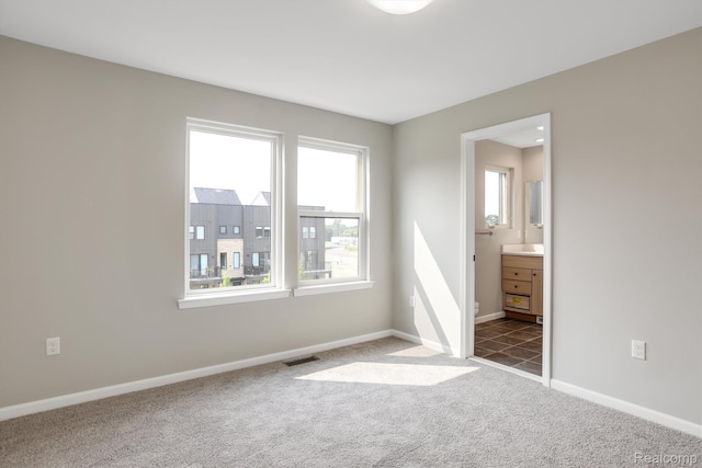 1058 Hampton Cir Unit 74, Detroit, MI 48207 - empty room featuring carpet and plenty of natural light