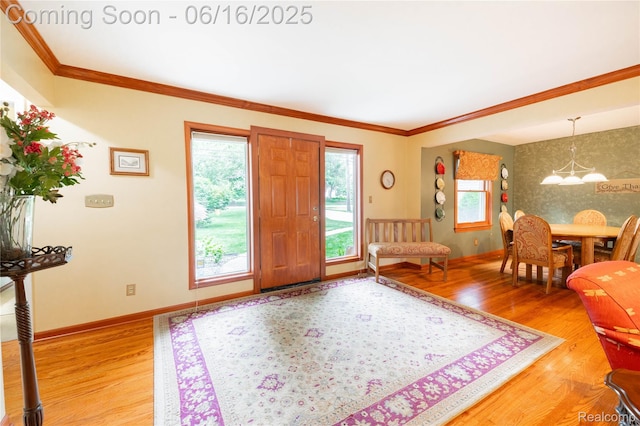 21781 Thorofare Rd, Grosse Ile, MI 48138 - entrance foyer with plenty of natural light, wood finished floors, a chandelier, and ornamental molding