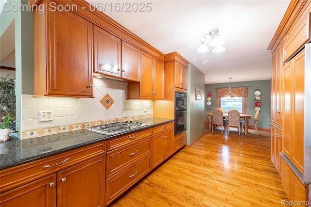 21781 Thorofare Rd, Grosse Ile, MI 48138 - kitchen featuring stainless steel gas cooktop, light wood-type flooring, brown cabinetry, and backsplash