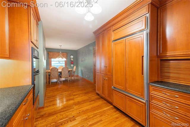 21781 Thorofare Rd, Grosse Ile, MI 48138 - hallway featuring a chandelier and light wood-style flooring