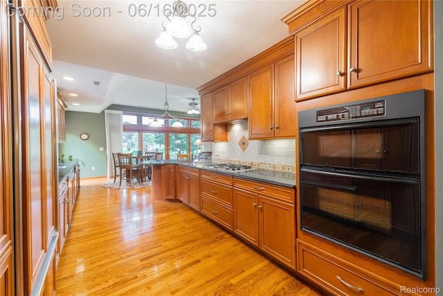 21781 Thorofare Rd, Grosse Ile, MI 48138 - kitchen with brown cabinetry, light wood-type flooring, a chandelier, backsplash, and recessed lighting
