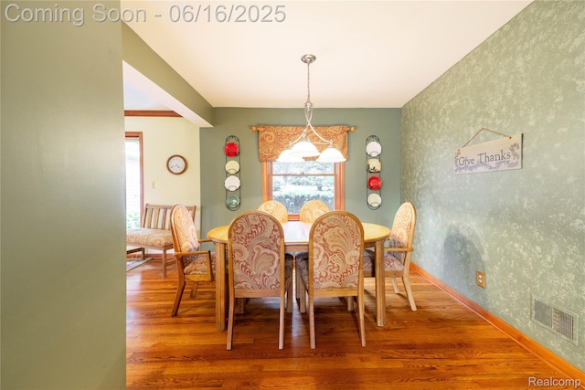21781 Thorofare Rd, Grosse Ile, MI 48138 - dining space featuring wood finished floors and wallpapered walls