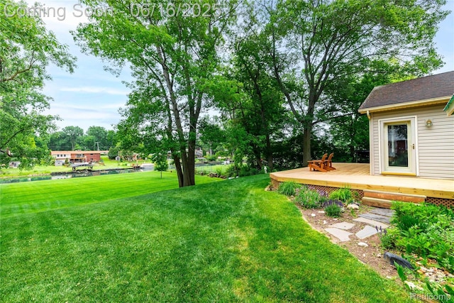 21781 Thorofare Rd, Grosse Ile, MI 48138 - view of green lawn featuring a deck with water view