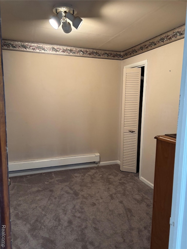 59 W High St, Metamora, MI 48455 - spare room with a baseboard heating unit and dark colored carpet