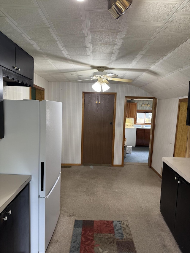 1026 Yeomans St, Ionia, MI 48846 - kitchen with freestanding refrigerator, ceiling fan, light carpet, light countertops, and washer / dryer