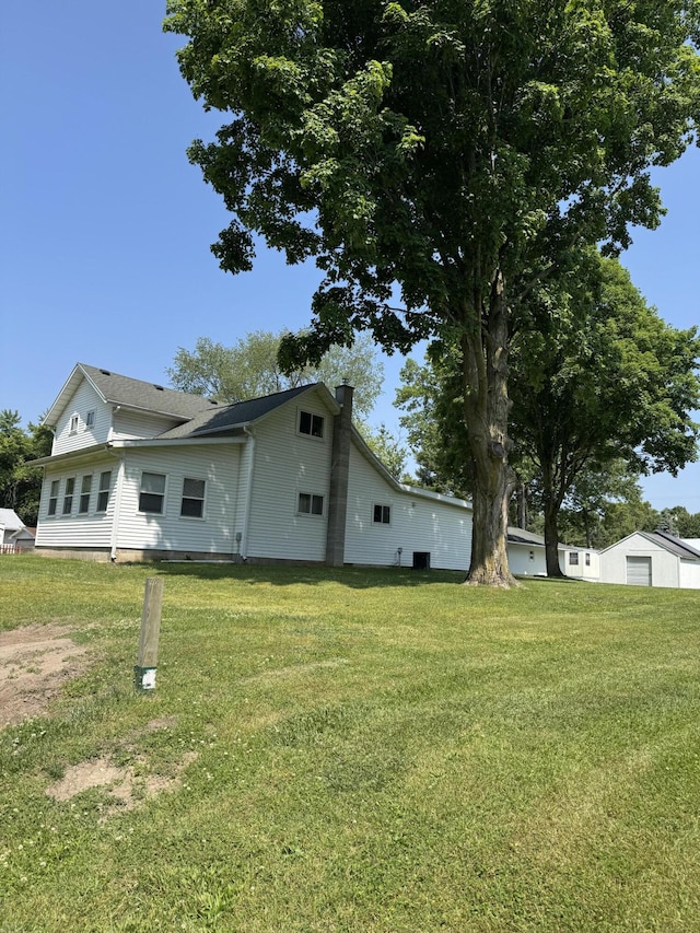 1026 Yeomans St, Ionia, MI 48846 - view of front of property featuring a chimney and a front lawn