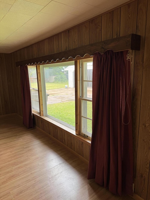 1026 Yeomans St, Ionia, MI 48846 - empty room with wooden walls and light wood-type flooring