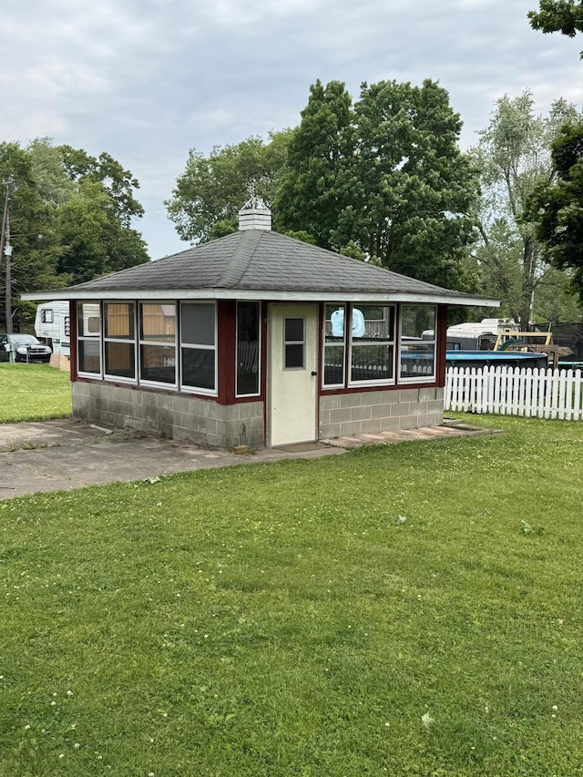 1026 Yeomans St, Ionia, MI 48846 - view of front of house featuring concrete block siding and a shingled roof
