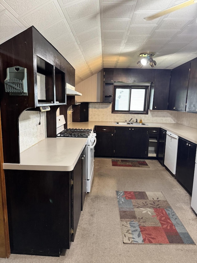 1026 Yeomans St, Ionia, MI 48846 - kitchen featuring white appliances, range hood, light countertops, decorative backsplash, and vaulted ceiling