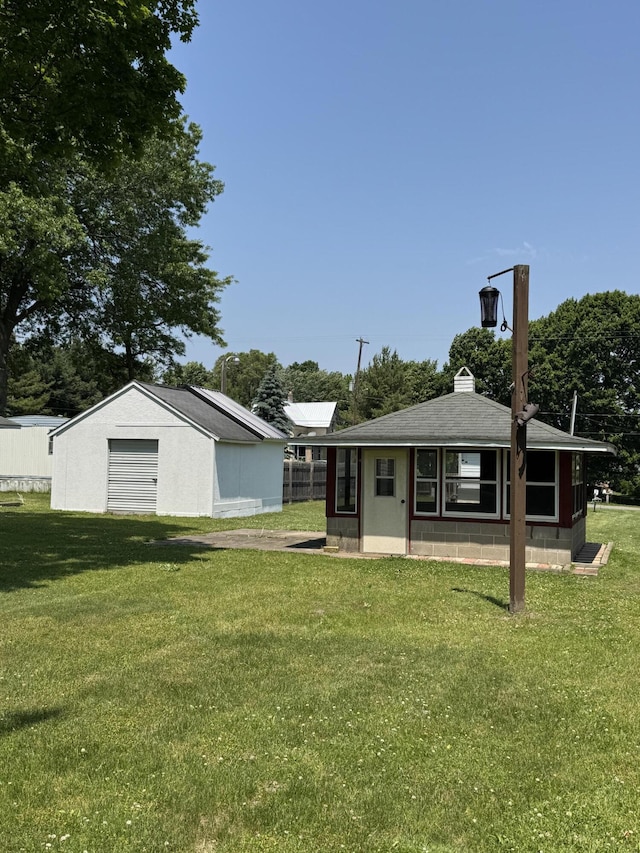 1026 Yeomans St, Ionia, MI 48846 - view of green lawn with an outbuilding and a garage