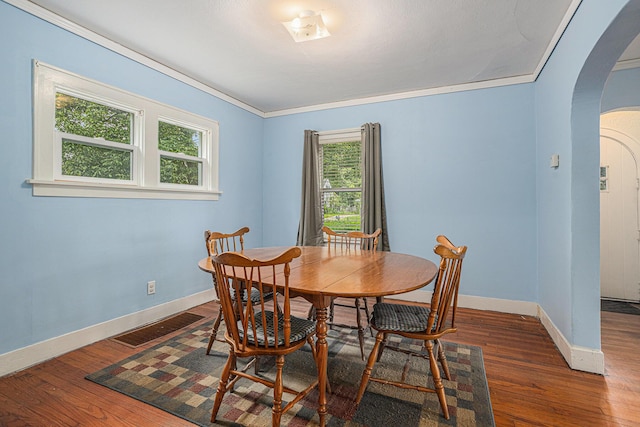 5147 N Riverview Dr, Kalamazoo, MI 49004 - dining room with arched walkways, wood finished floors, and crown molding