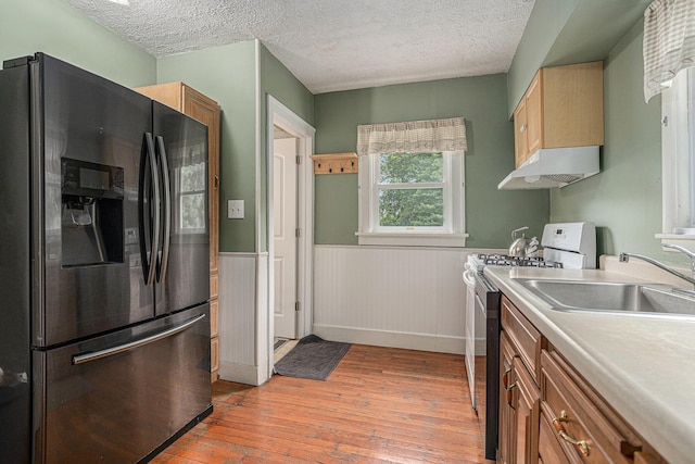 5147 N Riverview Dr, Kalamazoo, MI 49004 - kitchen featuring refrigerator with ice dispenser, white stove, under cabinet range hood, a textured ceiling, and light wood-style floors