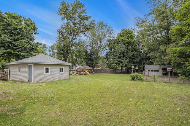 5147 N Riverview Dr, Kalamazoo, MI 49004 - view of yard featuring a playground, an outbuilding, and view of scattered trees