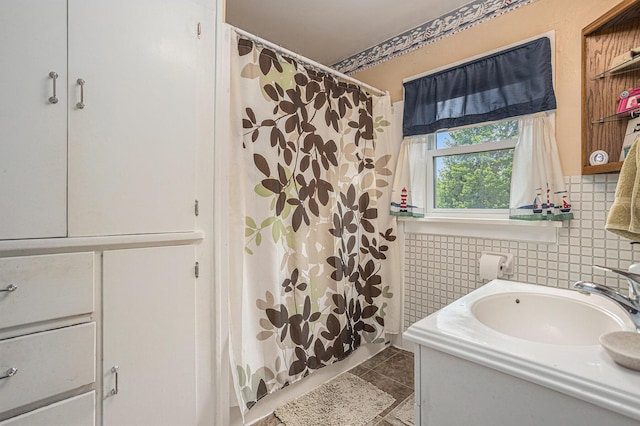 5147 N Riverview Dr, Kalamazoo, MI 49004 - full bathroom featuring a shower with shower curtain, tile patterned flooring, vanity, and backsplash