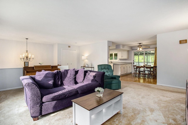 6958 Paddock Ln, Jackson, MI 49201 - living area with light carpet, a chandelier, and a ceiling fan