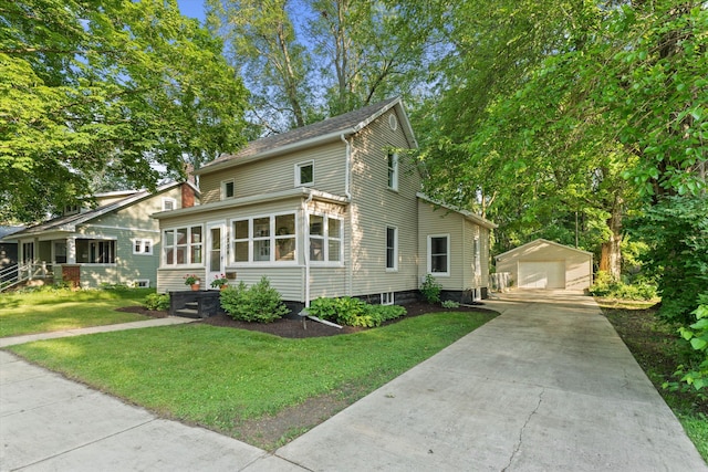1334 Regent St, Niles, MI 49120 - view of front of house featuring an outdoor structure, a garage, a front lawn, and a sunroom