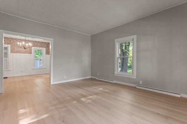 1334 Regent St, Niles, MI 49120 - unfurnished room with a baseboard radiator, a chandelier, and light wood-style floors