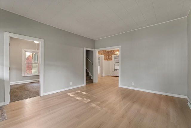 1334 Regent St, Niles, MI 49120 - spare room with light wood-style flooring, stairs, and a chandelier