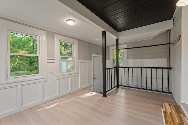 1334 Regent St, Niles, MI 49120 - unfurnished room with a decorative wall, wood finished floors, healthy amount of natural light, and a wainscoted wall