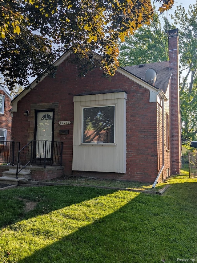 19947 Kinloch, Redford, MI 48240 - view of front of property with a front yard, a chimney, and brick siding