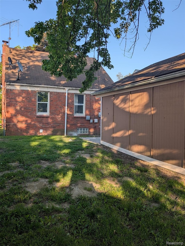 19947 Kinloch, Redford, MI 48240 - back of house featuring a yard, roof with shingles, brick siding, and a chimney