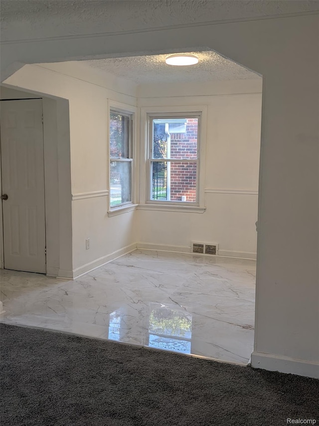 19947 Kinloch, Redford, MI 48240 - empty room with marble tiled floors and a textured ceiling