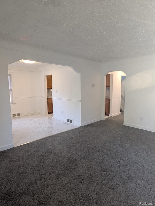 19947 Kinloch, Redford, MI 48240 - empty room featuring arched walkways, carpet floors, and a textured ceiling