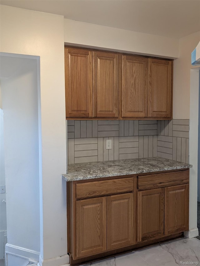 19947 Kinloch, Redford, MI 48240 - kitchen featuring brown cabinets, light marble finish flooring, and light stone countertops