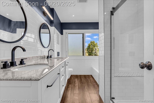 100 Mornington Ct, Canton, MI 48188 - full bathroom with wood finished floors, tile walls, double vanity, and a shower stall