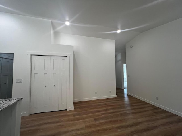 2959 Polaris Ave, Kalamazoo, MI 49004 - unfurnished bedroom featuring dark wood-style flooring and vaulted ceiling