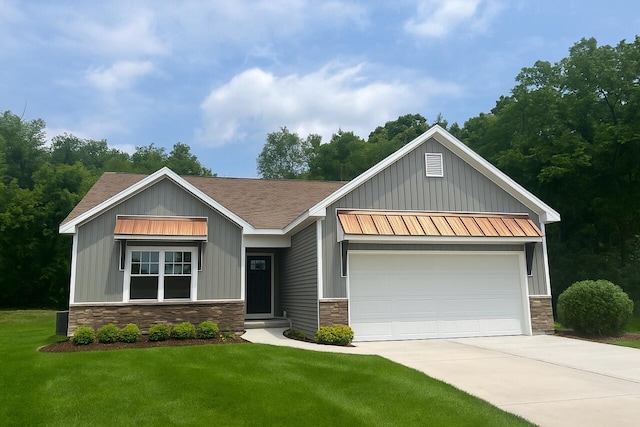 2959 Polaris Ave, Kalamazoo, MI 49004 - view of front of property with stone siding, board and batten siding, and concrete driveway