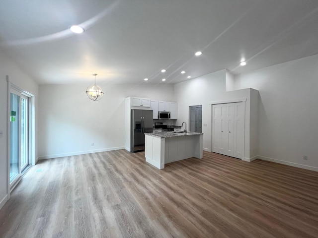 2959 Polaris Ave, Kalamazoo, MI 49004 - kitchen featuring stainless steel appliances, open floor plan, recessed lighting, white cabinets, and wood finished floors