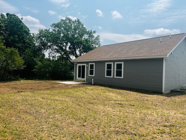 2959 Polaris Ave, Kalamazoo, MI 49004 - back of property featuring a patio area, a yard, and roof with shingles