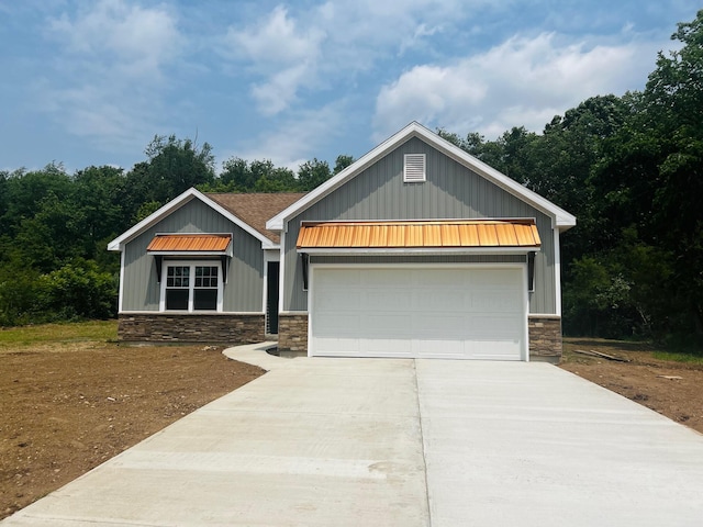 2959 Polaris Ave, Kalamazoo, MI 49004 - craftsman inspired home with stone siding, board and batten siding, concrete driveway, and a garage