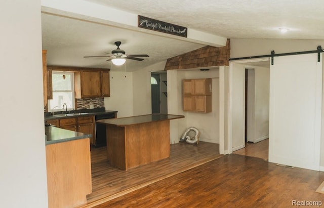 11709 Old Belding Rd NE, Belding, MI 48809 - kitchen featuring black dishwasher, a barn door, a center island, and dark wood finished floors