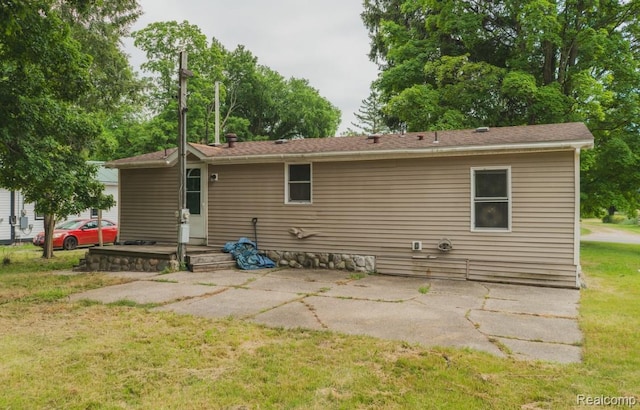 11709 Old Belding Rd NE, Belding, MI 48809 - rear view of house with a patio area and a lawn