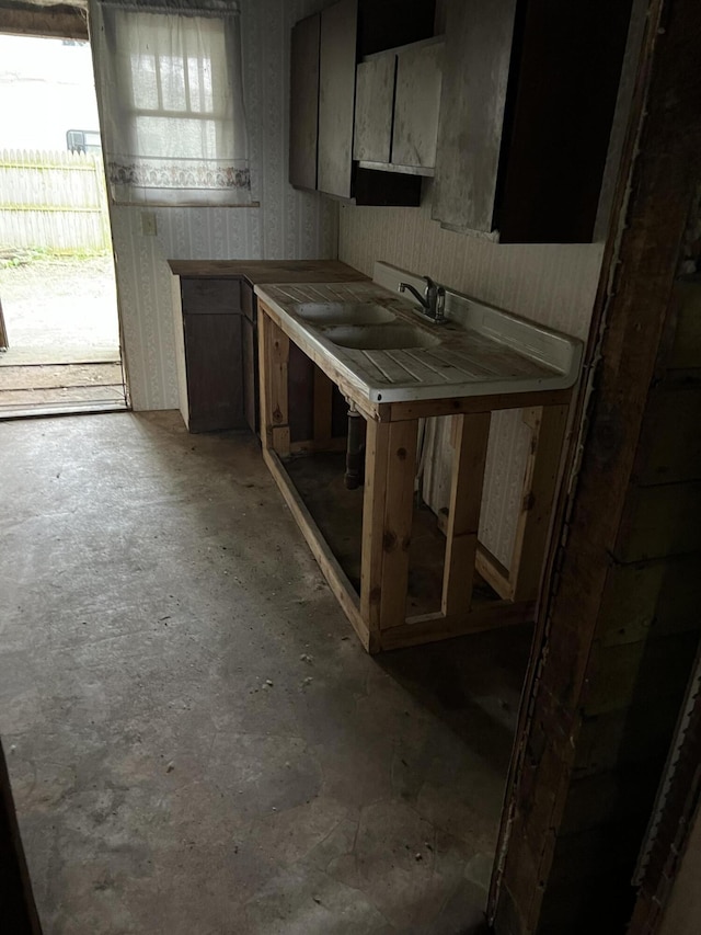 102 Allett St, Allegan, MI 49010 - kitchen with concrete flooring and wallpapered walls