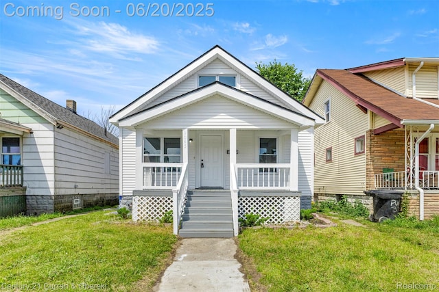 9045 Burnette St, Detroit, MI 48204 - shotgun-style home featuring a porch and a front yard