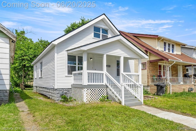 9045 Burnette St, Detroit, MI 48204 - view of front facade featuring a porch and a front yard