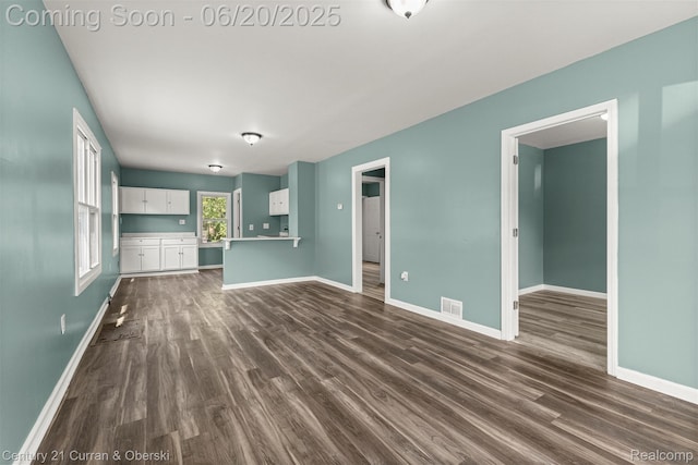 9045 Burnette St, Detroit, MI 48204 - unfurnished living room featuring dark wood-type flooring and baseboards