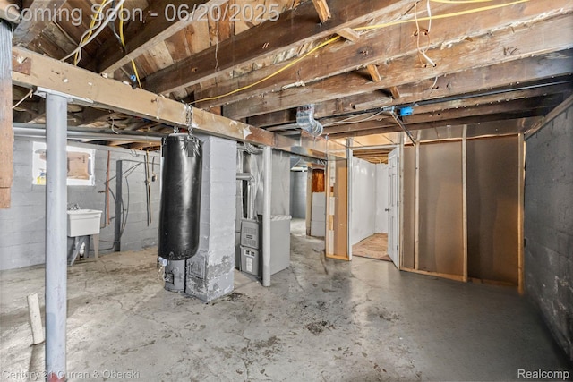 9045 Burnette St, Detroit, MI 48204 - unfinished basement featuring heating unit and a sink