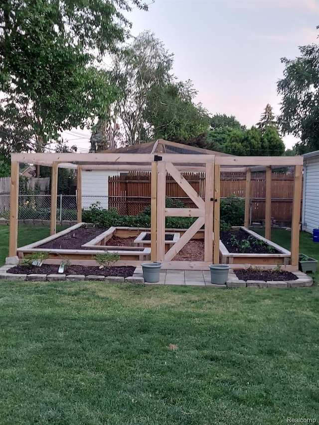 31740 Nelson Dr, Warren, MI 48088 - yard at dusk with a vegetable garden