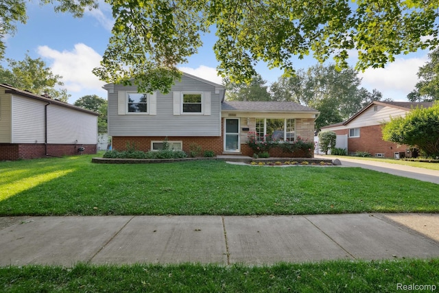 31740 Nelson Dr, Warren, MI 48088 - split level home featuring a front yard and brick siding