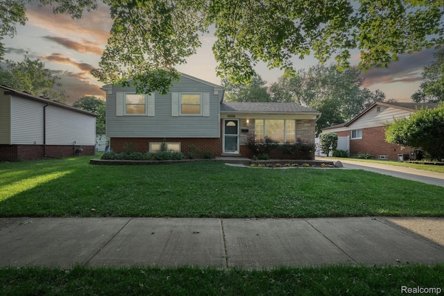 31740 Nelson Dr, Warren, MI 48088 - tri-level home with a front lawn and brick siding