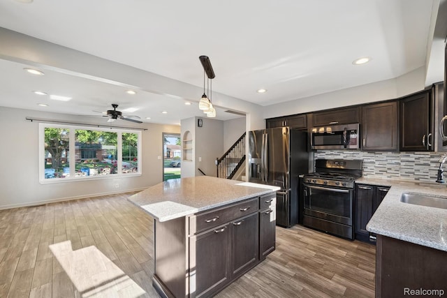 31740 Nelson Dr, Warren, MI 48088 - kitchen with appliances with stainless steel finishes, dark brown cabinetry, light wood-type flooring, tasteful backsplash, and recessed lighting