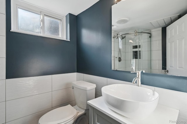 31740 Nelson Dr, Warren, MI 48088 - bathroom with a tile shower, vanity, and tile walls