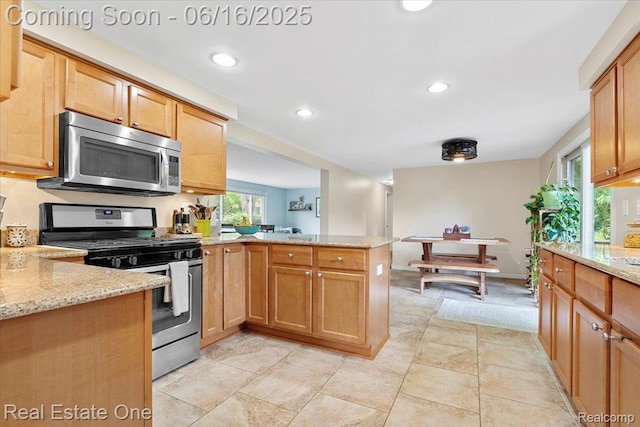 20558 Meridian Rd, Grosse Ile, MI 48138 - kitchen featuring appliances with stainless steel finishes, a peninsula, light stone countertops, and recessed lighting