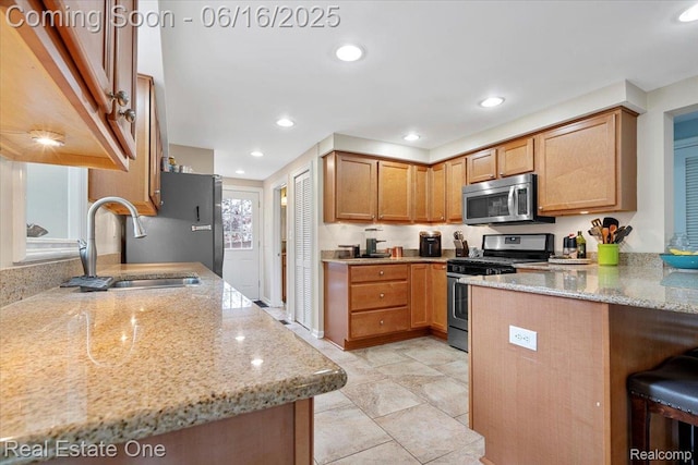 20558 Meridian Rd, Grosse Ile, MI 48138 - kitchen featuring stainless steel appliances, light stone counters, a peninsula, a kitchen breakfast bar, and recessed lighting