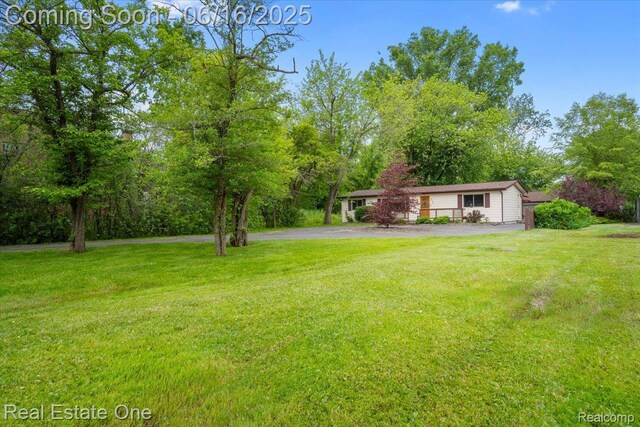 20558 Meridian Rd, Grosse Ile, MI 48138 - view of green lawn with asphalt driveway