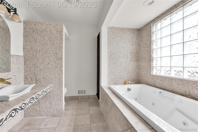 25044 Comfort, Center Line, MI 48015 - bathroom featuring plenty of natural light, a tub with jets, tile patterned flooring, and vanity